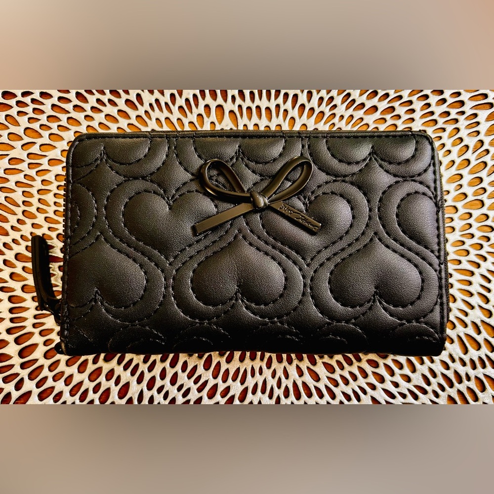 Betsey Johnson XOKARA
Quilted Black Zip Around Wallet
With Metal Bow Detail